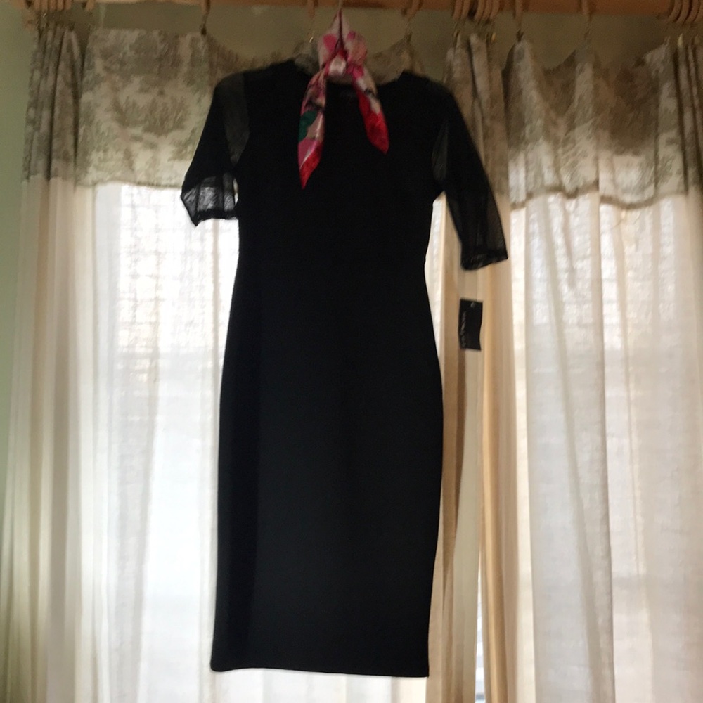 Sleek black contouring midi dress.